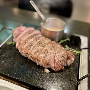 NY Steak.  Perfectly cooked to medium rare.  Served on burning hot iron plate which kept it warm.  With butter.