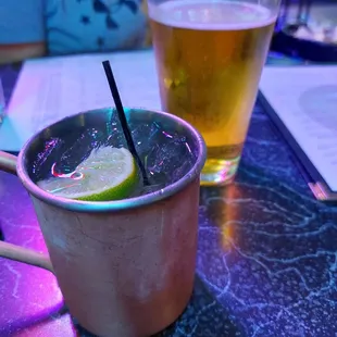 a drink in a copper mug with a lime wedge