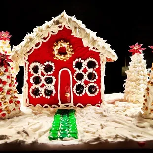 a ginger house and christmas trees