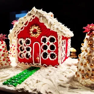 a ginger house and christmas trees