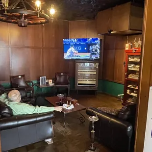 a man sitting on a couch watching tv