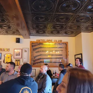 a group of people sitting at a bar