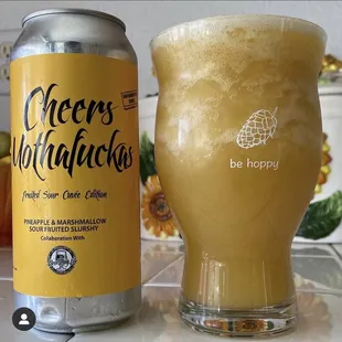 a glass of beer next to a can of beer