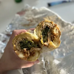 a hand holding a sandwich