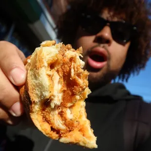 a man holding a piece of food