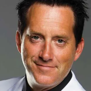 a man in a white shirt and black tie