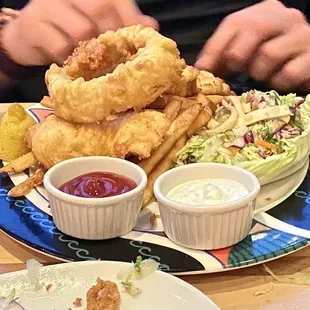 Halibut fish and chips, calamari in the foreground.