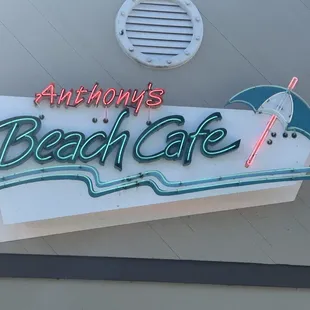 a neon sign for anthony&apos;s beach cafe