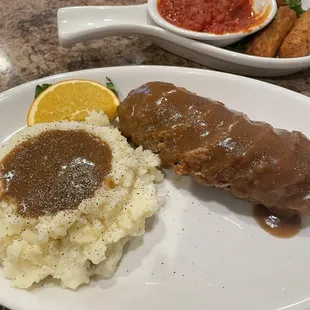 Meatloaf and mashed potatoes with gravy and mozzarella sticks