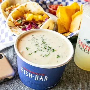 a bowl of fish bar soup and a drink