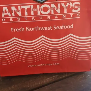 a red bag with a fish on it