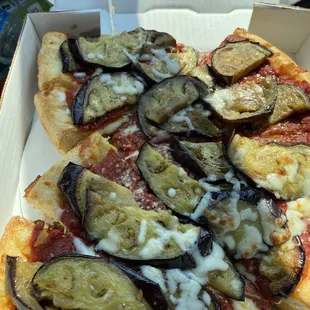 Fresh eggplant partially grilled with garlic before baked on top of deep dish pizza . A whole meal with a fresh salad !