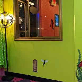 a bright green wall with a window