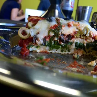 Inside of veggie single slice with spinach, mushrooms, onion, feta. Added black and green olives. So, so good.