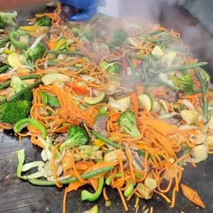 a pile of vegetables being cooked