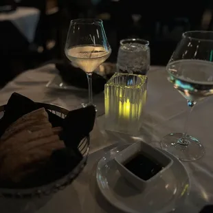 a glass of wine and a plate of bread