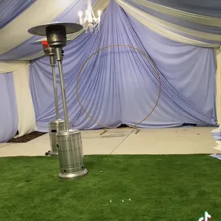 20x30 Ivory w/Lilac draping. Back wall full Lilac with 2 chandeliers.