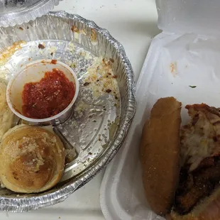 Rubbery Chicken Parm hero and tough garlic knots. The calzone is missing.