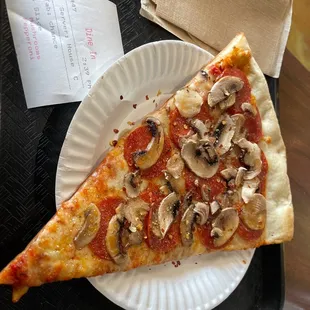 Cheese slice with added mushrooms and pepperoni