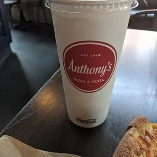 a slice of pizza and a drink