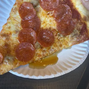Pepperoni and sausage pizza slice