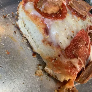 Sicilian thick with pepperoni and sausage. Very little sauce.