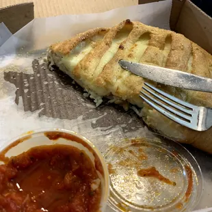 This is the extremely cheesy Greek calzone (with extra cheese).  I would give you a bite, but it&apos;s all gone now.