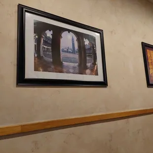 a hallway with framed pictures