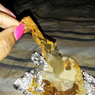 ows a hand holding a piece of food