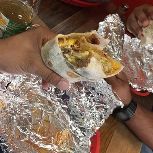 Potato and egg with bacon, bean and cheese burrito.