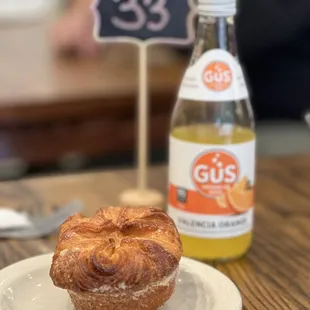 a pastry and a bottle of soda on a table