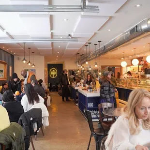 a crowded restaurant with people sitting at tables