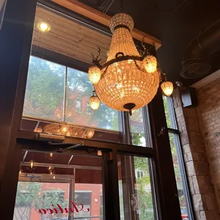 a chandelier hanging from the ceiling of a restaurant