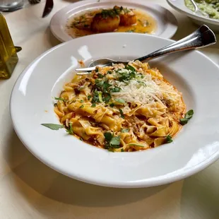 a plate of pasta and a glass of wine