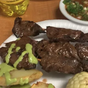 Anticuchos, salsa, green sauce, papa a la huancaina and Inca Kola! Delicious