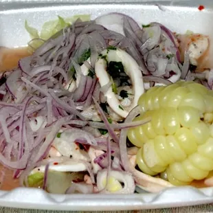Ceviche - Seafood Salad with raw squid, shrimp, fish and onion with lemon &amp; lime juice