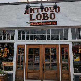 Outside. Storefront and outdoor patio. Free parking on the street.