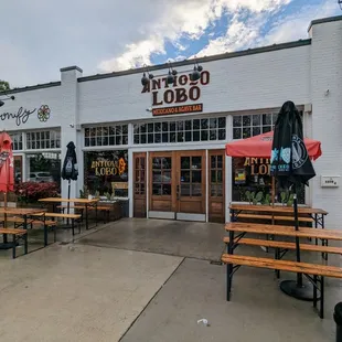 Outside. Storefront and outdoor patio. Free parking on the street.