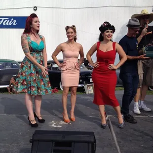 a group of women in dresses