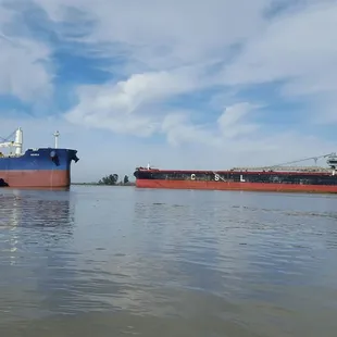 Two ships passing...red &amp; black came from under Antioch bridge..blue &amp; red from Pittsburg