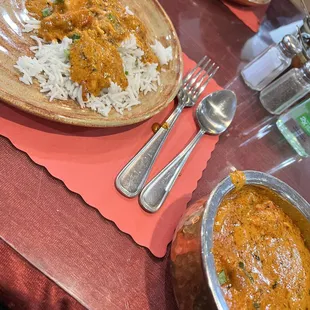 a plate of rice and a bowl of curry
