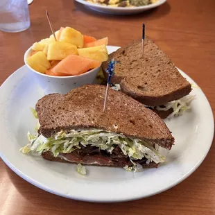 a sandwich and a bowl of fruit