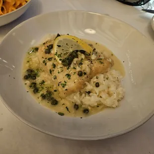 Baked haddock with capers and lemon over risotto