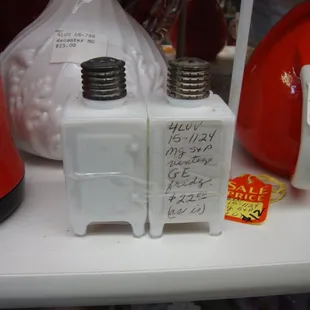 A pair of milk glass salt &amp; pepper shakers from the 1930s - GE Monitor Top Refrigerators.