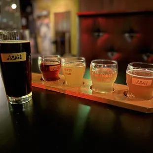 a row of beer glasses on a bar
