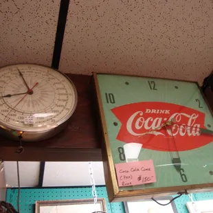 Some interesting clocks - a vintage military time clock and a 1960s Coca-Cola clock.
