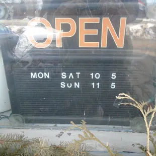 Hours of operation, front entry door.