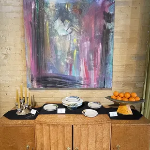 Ceramic work displayed on some of the antique pieces in the event space.