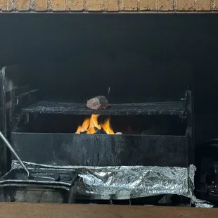 Chateaubriand cooking over an open fire.