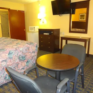Rooms all include flat screen TV, Refrigerator, Microwave, Dresser, Table, Chairs, Mirror, Lamps